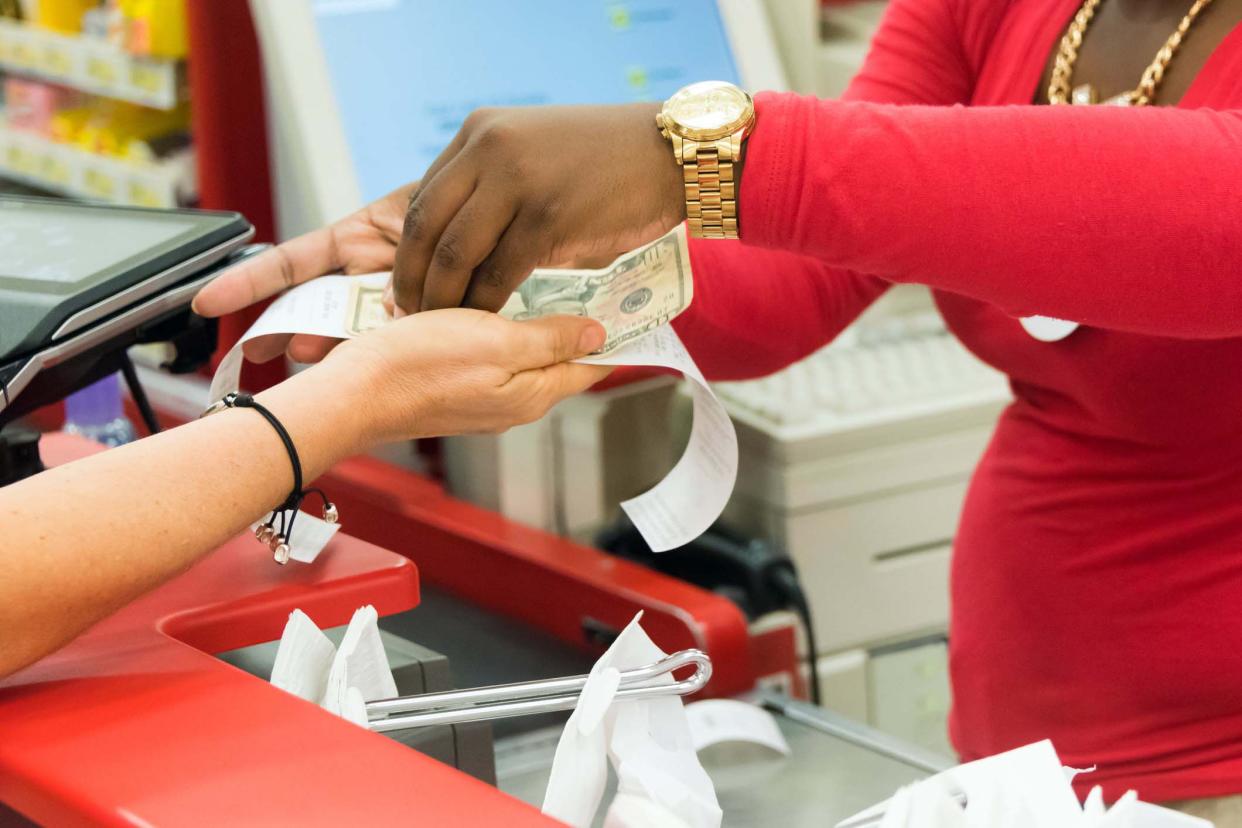 handing cash to cashier