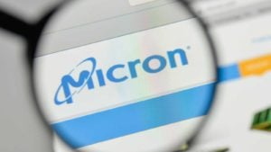 A magnifying glass zooms in on the logo for Micron Technology, Inc. (MU)