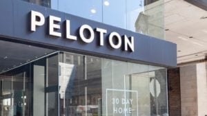 Peloton (PTON stock) sign on city storefront. Peloton layoffs