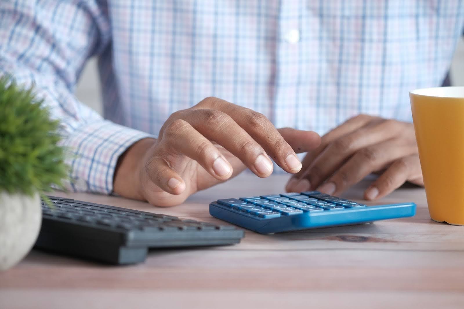 Man with calculator at a desk.