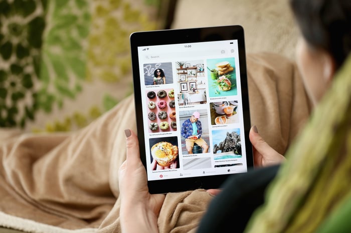 A person uses Pinterest's iPad app at home.