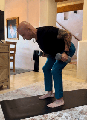 Personal trainer demonstrating dumbbell bent-over row