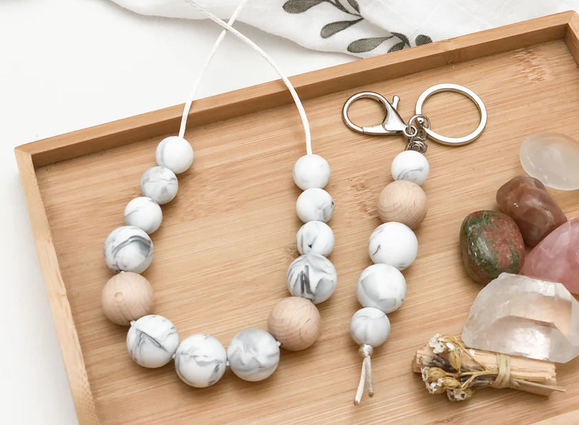 Silicone jewelry necklaces displayed on a wooden tray