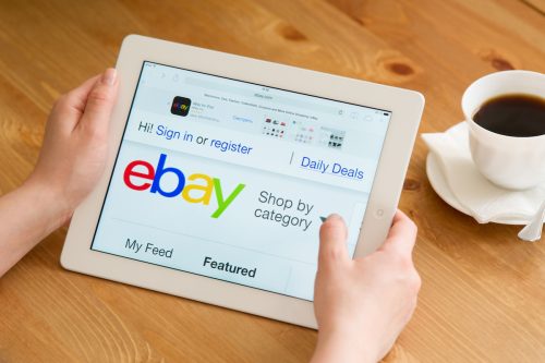 Close up of a person using an iPad to shop on eBay