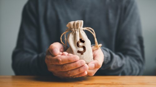 Man hands holding money bag