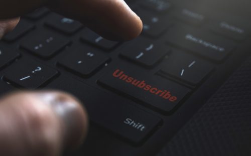 finger poised over unsubscribe button on keyboard