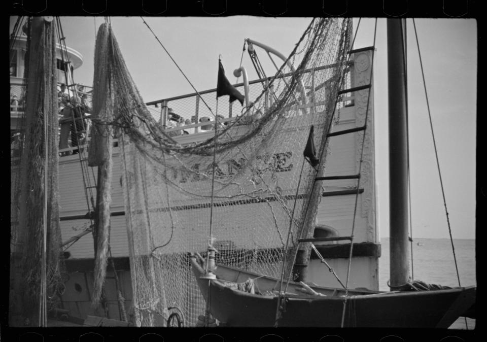 This U.S. Library of Congress public domain photo is captioned: 'A fishing boat in front of the S.S. 'Romance,' a tourist boat which used to ply between Boston and Provincetown and has since sunk in Boston Harbor. Provincetown, Massachusetts'.