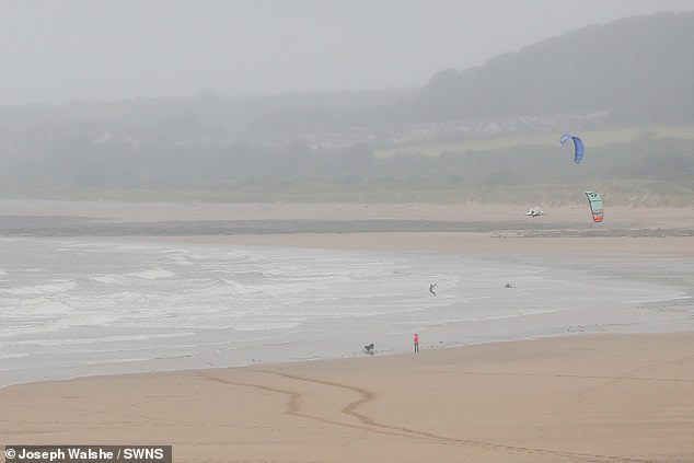 A number of workers go to seaside cafes to work and look at the beach