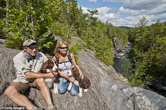 Researchers' state rankings also revealed a possibly instructive trend: states with low equality for women also had low financial well-being for men. 'Gender inequality is negatively associated with economic growth,' they wrote. Above, man and a woman in Maine enjoy a hike