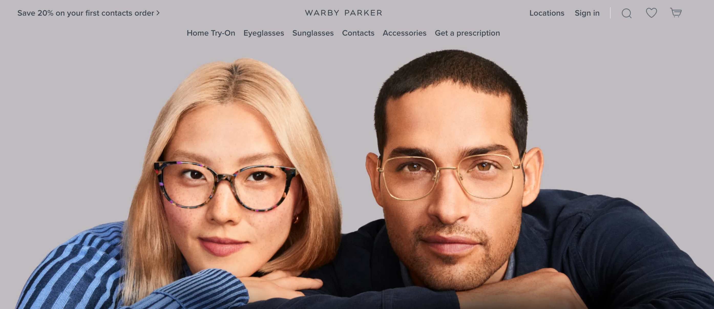 Warby Parker homepage with two people wearing glasses, staring at camera