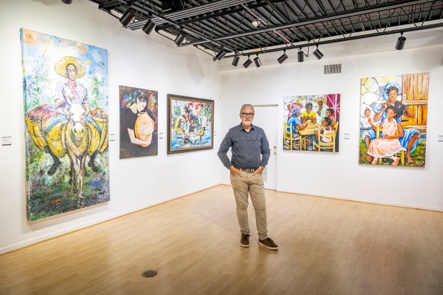 Peter Schreyer, Crealdé's CEO and executive director, is surrounded by the work of Hatian-American artist Patrick Noze in the gallery at Crealdé School of Art in Winter Park on Sept. 21, 2023. Schreyer is stepping down at the end of the year. (Patrick Connolly/Orlando Sentinel)