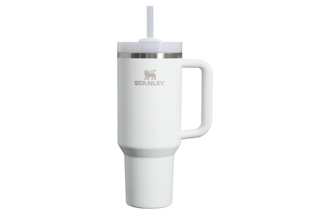 A white tumbler mug with a straw.