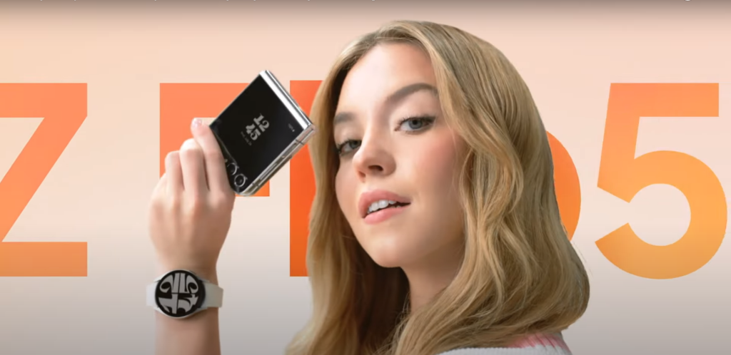 Sydney Sweeney holds a Z Flip 5 phone