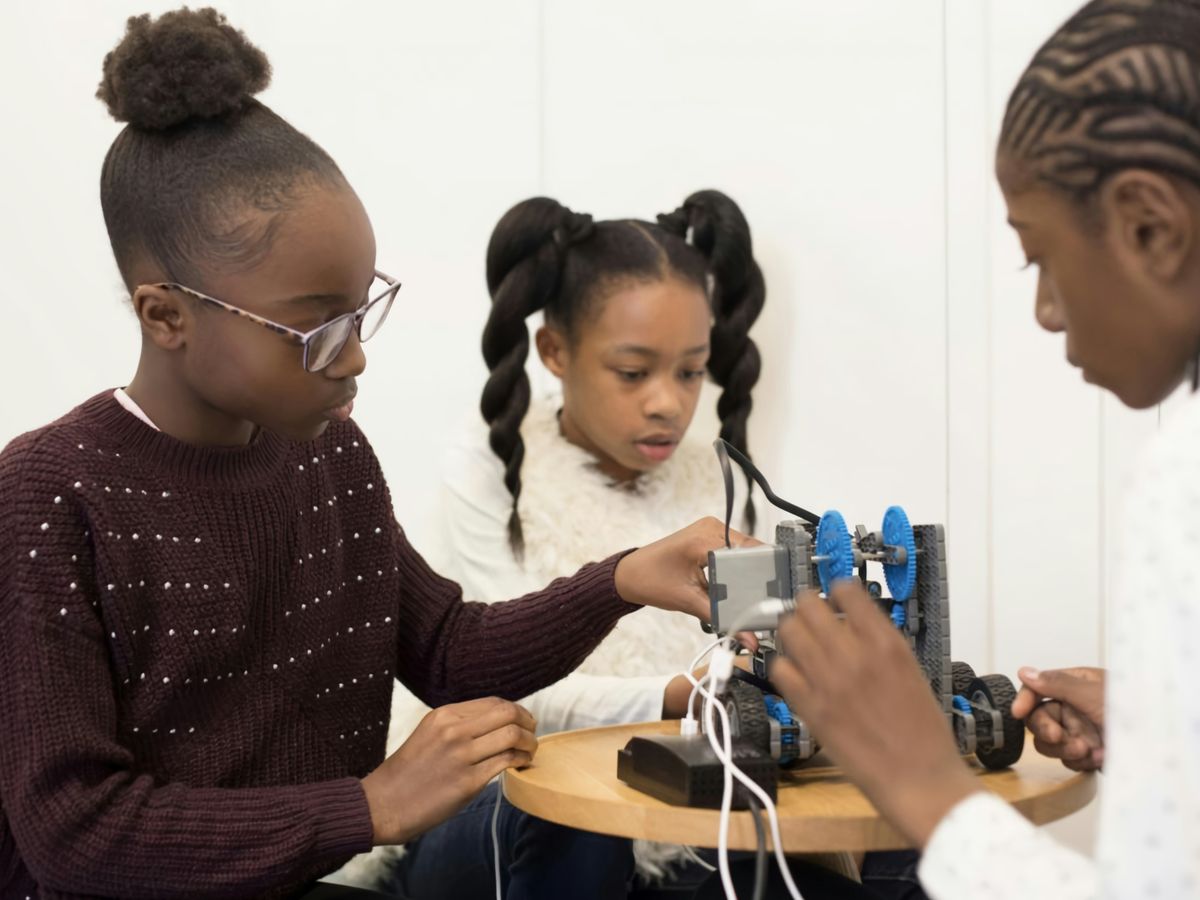 two girls are working on a project together