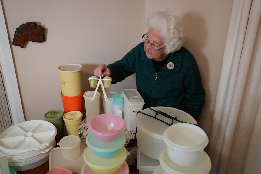 Alison Donnan holds up a bit of Tupperware.