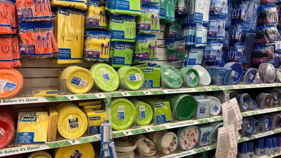 Store display wall of different colors of paper plates, tableclothes napkins and plastic silverware