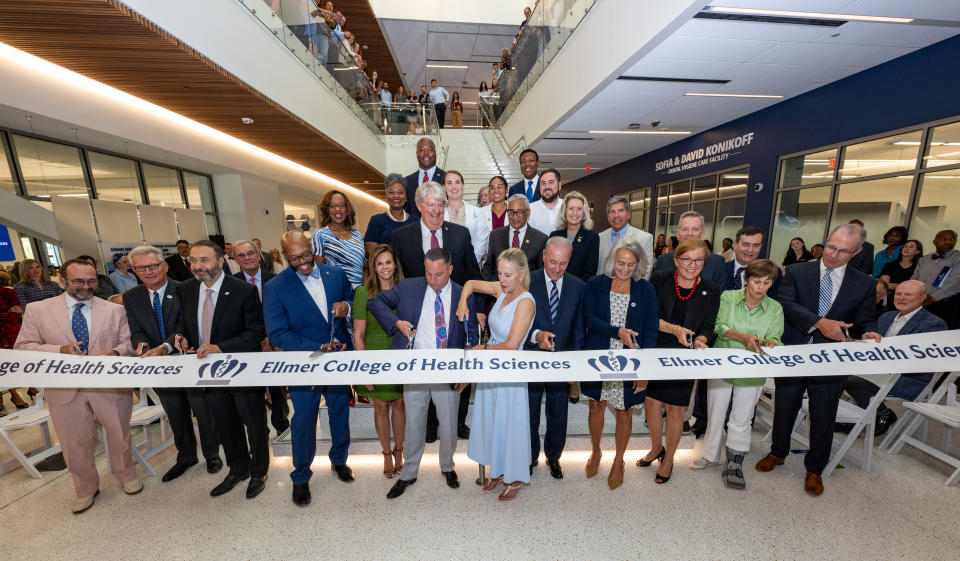 University leaders, donors and state and local officials get ready to cut the ribbon at the opening celebration of the Ellm er College of Health Sciences on Thursday, Aug. 29.