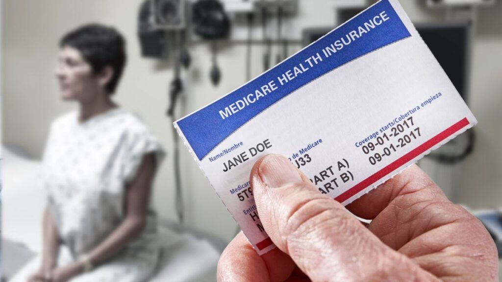 When To Sign Up for Medicare; Woman In Doctors Office with Medicare Card