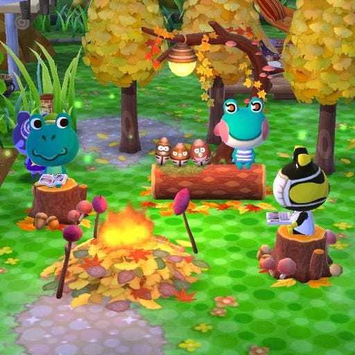 Screenshot of Animal Crossing Pocket Camp area set up to look like an autumnal camping trip for the frog characters.