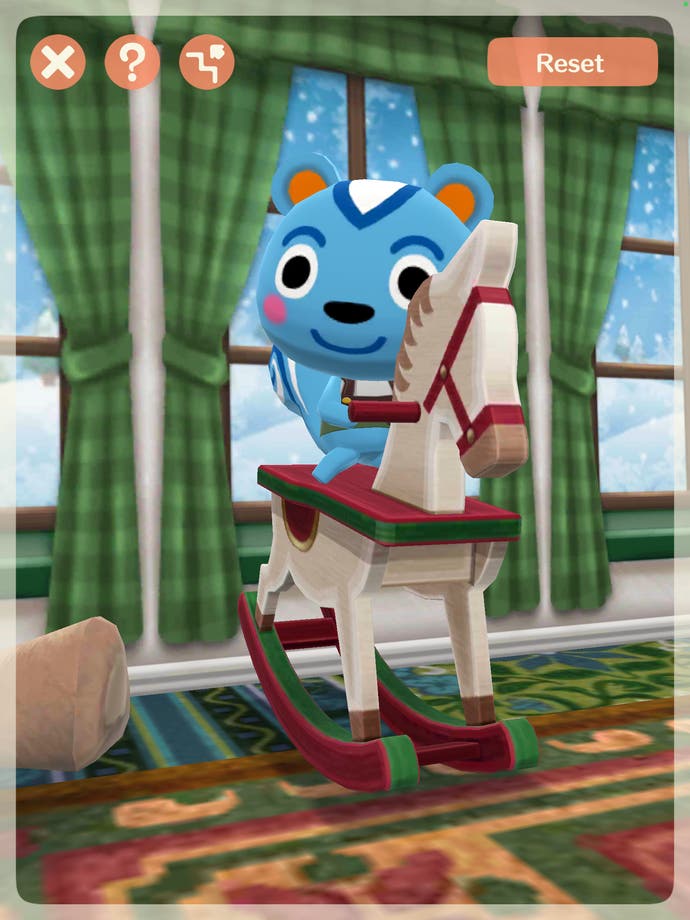 Screenshot of Animal Crossing Pocket Camp taken in AR photo mode. The photo is of the blue chipmunk Filbert on a rocking horse.