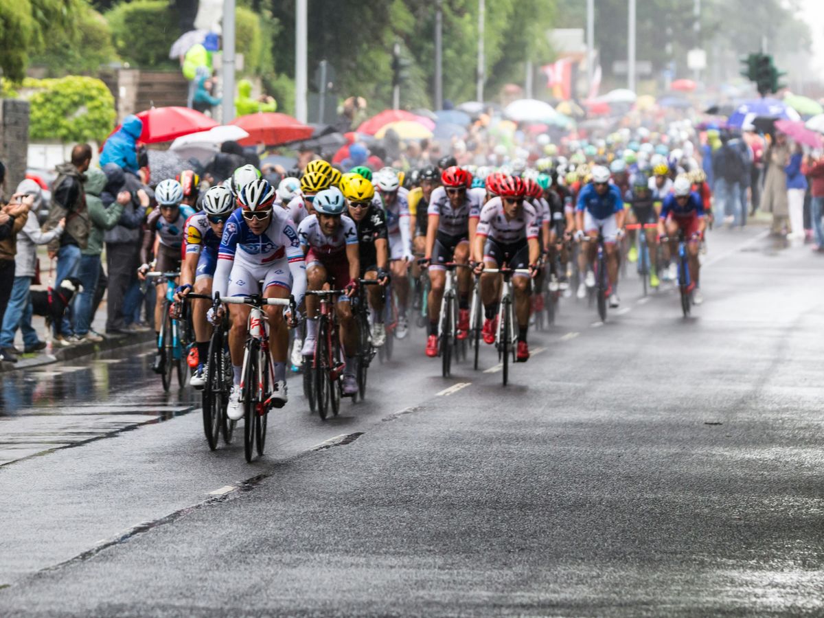 people riding bicycle on road during daytime