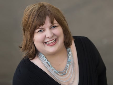 Woman in a black blouse smiles