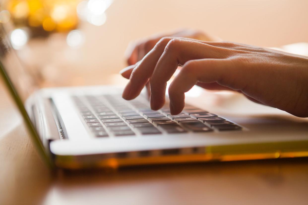 Woman is typing on the laptop