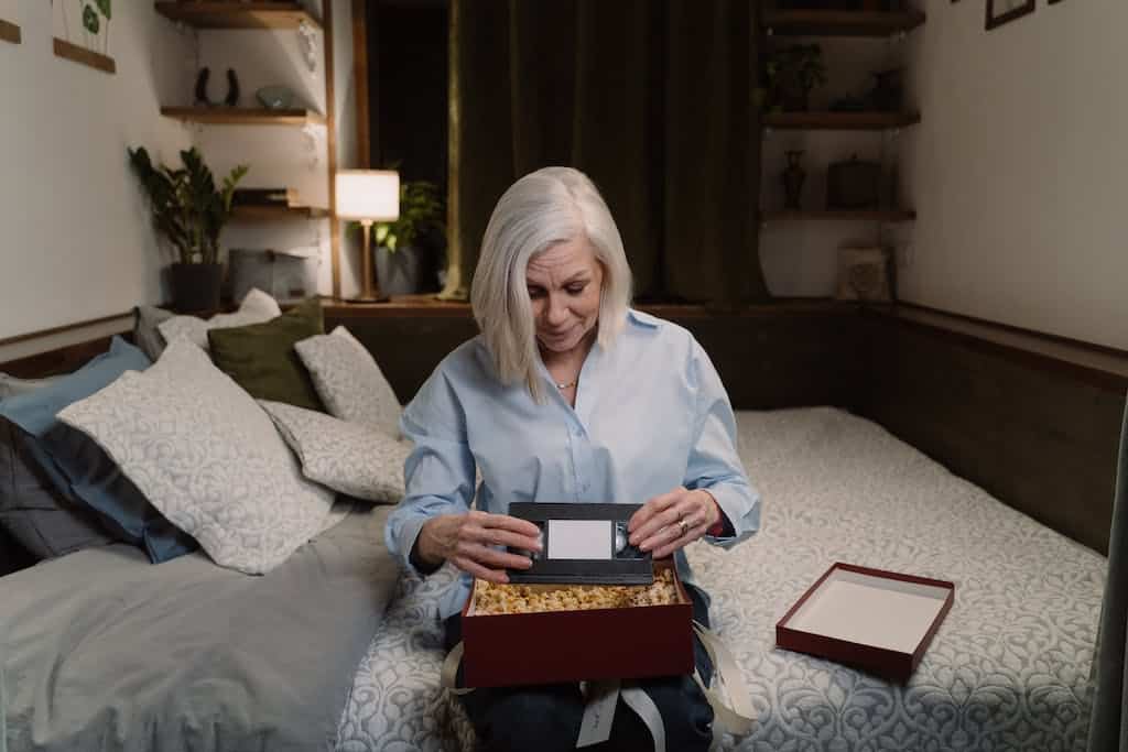 A Woman Holding a Vintage VHS Videotape