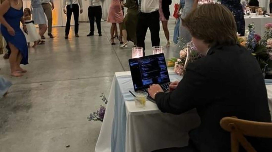 Techie works on laptop during own wedding