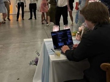 Techie works on laptop during own wedding