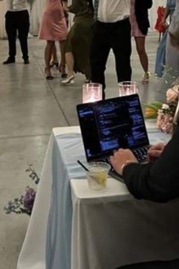 Techie works on laptop during own wedding