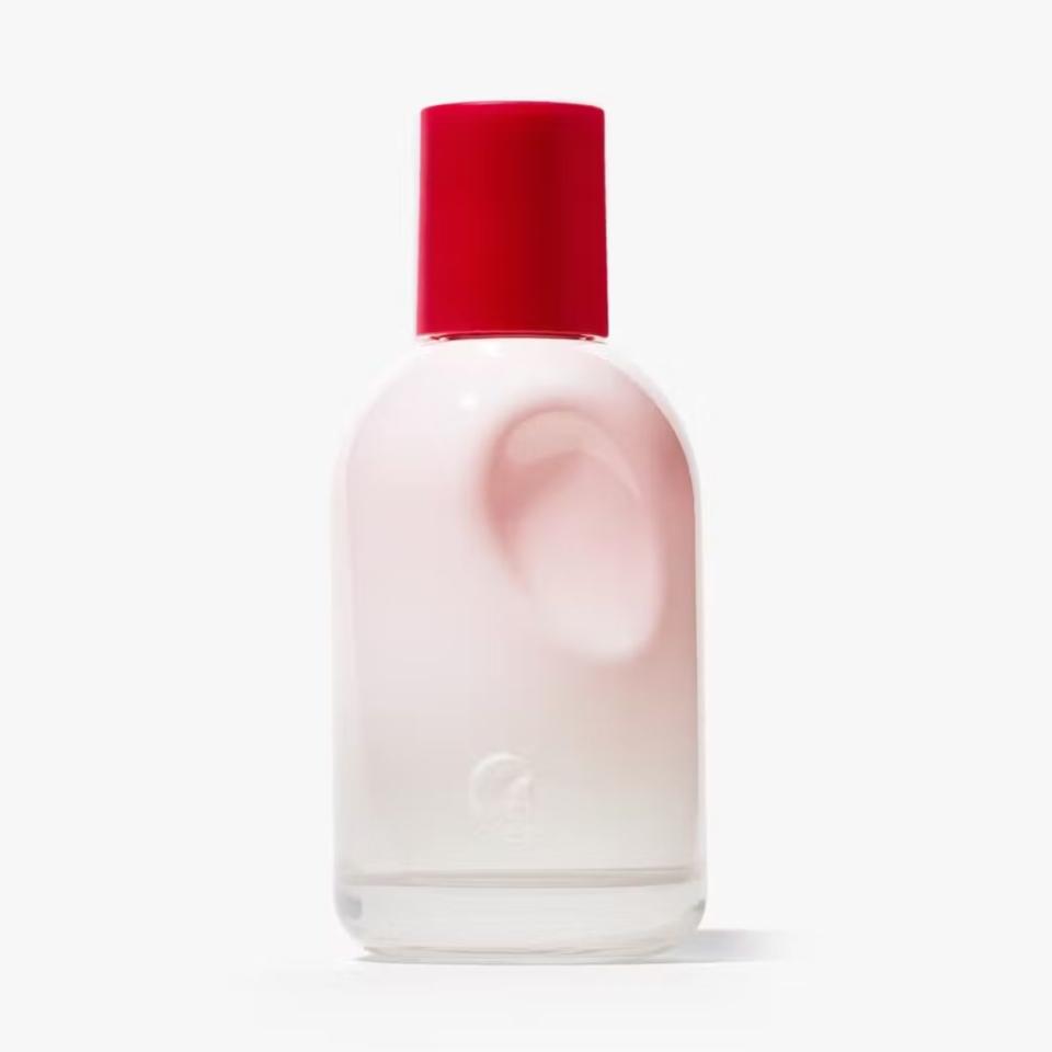 pink bottle of glossier perfume with red cap