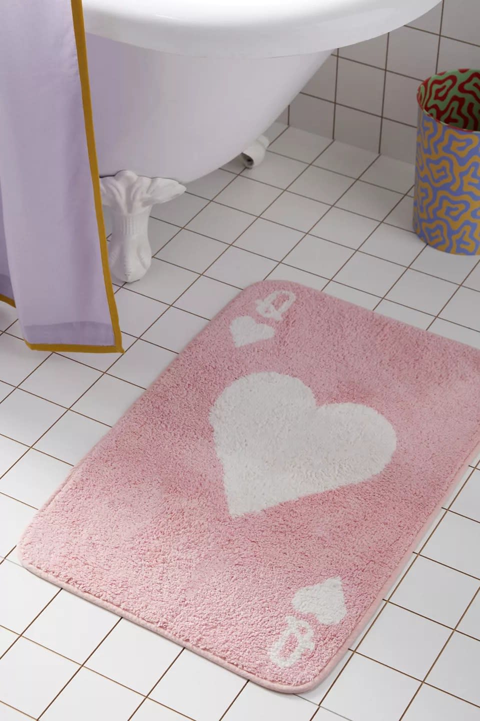 pink and white queen of heart pattern bath mat on floor